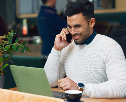 Man, phone call and laptop at cafe for remote work