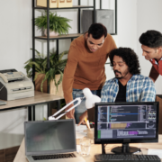 Three men collaborating, focused on managed IT services for office operations.