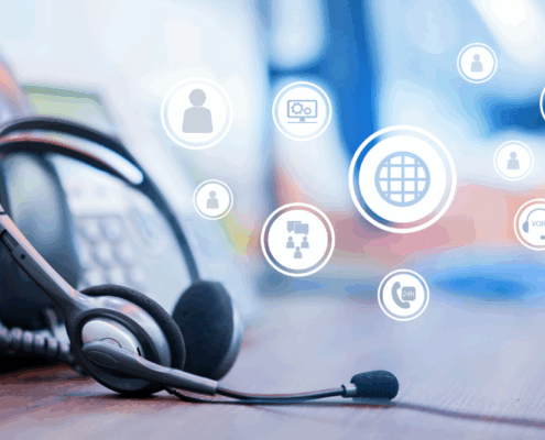 Desk scene with a headset and VoIP phone, representing a call center concept focused on VoIP phone system features.