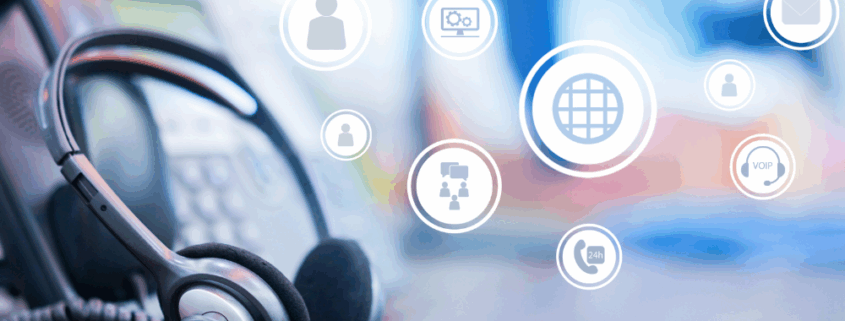 Desk scene with a headset and VoIP phone, representing a call center concept focused on VoIP phone system features.